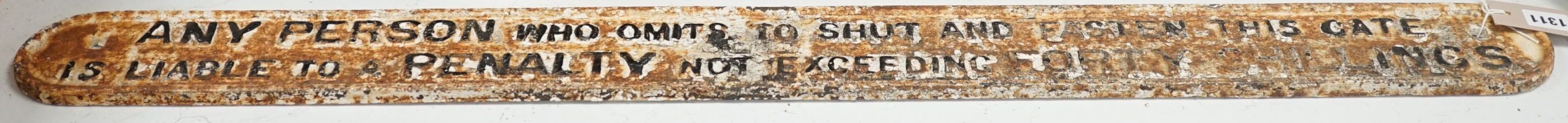 A cast iron gate sign, “any person who omits to shut and fasten this gate is liable to a penalty not exceeding forty shillings.”, 101 cms long.